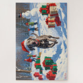 クリスマスの帽子をかぶって雪の中を走るワイマラナー ジグソーパズル (縦)