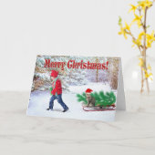 クリスマスの木と子と猫 / 雪のクリスマスツリーを家に運ぶ カード (黄色い花)