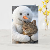 クリスマスの雪だるまがトラ猫を抱きしめている カード (黄色い花)