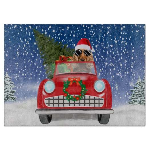 クリスマスの雪の中を車を運転するコッカー・スパニエル カッティングボード (正面)