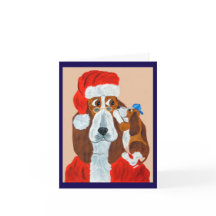 クリスマスの願い事をサンタに伝えるバセット・ハウンドの子犬