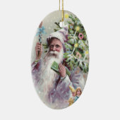 クリスマスツリーが付いている紫色のコートの旧式なサンタ セラミックオーナメント (右)