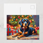 クリスマスツリーのそばのかわいい犬 シーズンポストカード (正面/裏面)