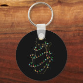 クリスマスツリーの光に照らされたサンタ黒猫 キーホルダー (正面)