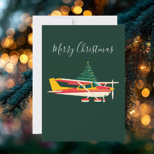 クリスマスツリーを運ぶセスナの飛行機の写真 楽しい シーズンカード