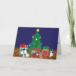 クリスマスツリーカードの下で遊ぶハスキー シーズンカード
