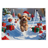 クリスマスハットをかぶったコッカプーが雪の中で走る ラージペーパーバッグ (正面)