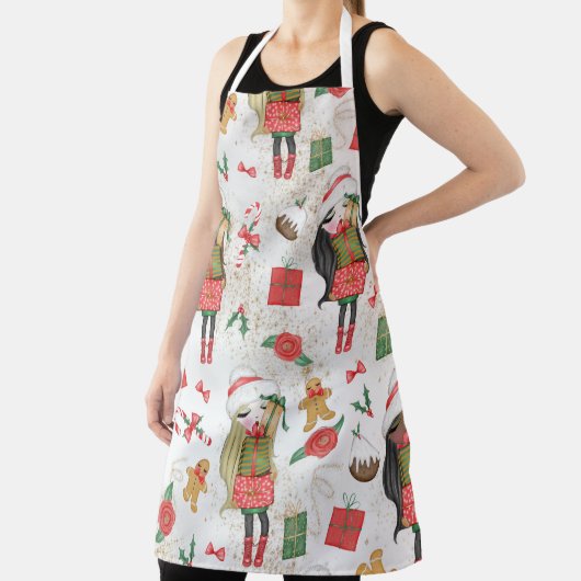 クリスマスプレゼントと花を飾ったかわいい女の子 エプロン (インサイチュ)