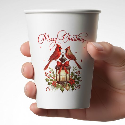 クリスマスランタンの上の水彩のショウジョウコウカンチョウ 紙コップ
