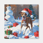 クリスマス帽をかぶった雪の中を走るグレイハウンド マグネット (正面)