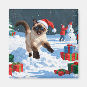 クリスマス帽をかぶった雪の中を走るシャム猫 マグネット (正面)