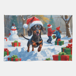 クリスマス帽子をかぶったダックスフンドの雪の中のラン キッチンタオル