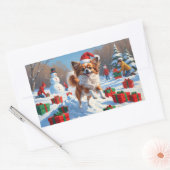 クリスマス帽子をかぶったパピヨンの雪中奔走 長方形シール (封筒)