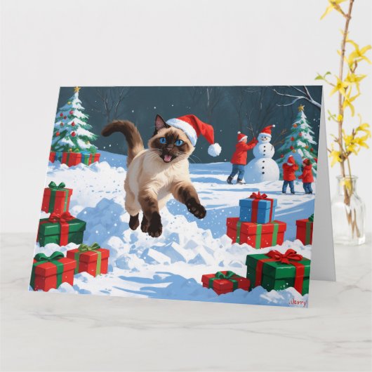 クリスマス帽子をかぶって雪の中を走るシャム猫 カード (黄色い花)
