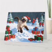 クリスマス帽子をかぶって雪の中を走るシャム猫 カード (正面)