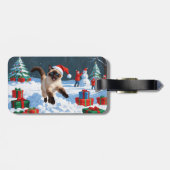 クリスマス帽子をかぶって雪の中を走るシャム猫 ラゲッジタグ (裏面横)