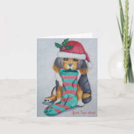 クリスマス用の服を着たかわいい黒と茶色の子犬 シーズンカード