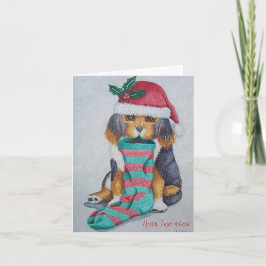 クリスマス用の服を着たかわいい黒と茶色の子犬 シーズンカード (正面)