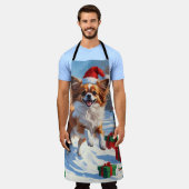 クリスマス走ハットで雪の中のパピロン犬 エプロン (着用した状態)