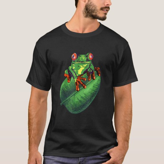 グリーンリーフに座っているかわいいカエル Tシャツ (正面)