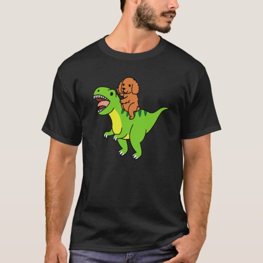 コッカー・スパニエルがレックス恐竜に乗る犬 Tシャツ (正面)