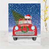 コーギー犬が雪のクリスマスに車を運転 カード (黄色い花)