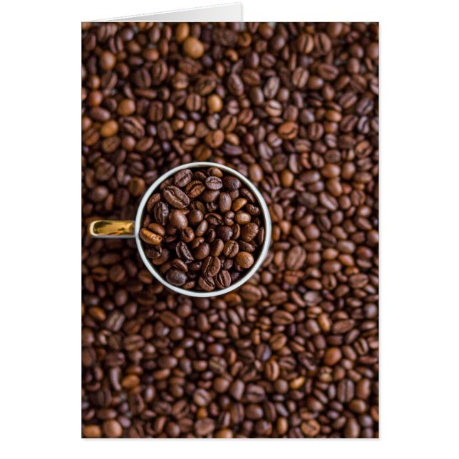 コーヒー豆の山と豆の入ったコーヒーカップ (正面)