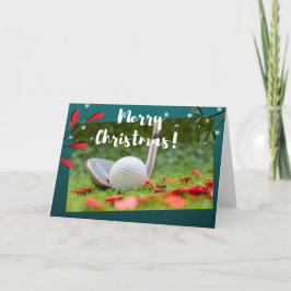ゴルフアイアンとボールがグリーンクリスマスに出ている カード
