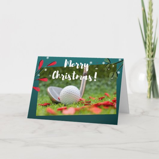 ゴルフアイアンとボールがグリーンクリスマスに出ている カード (正面)