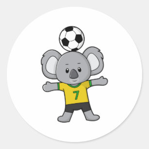 サッカーボールを持つサッカー選手としてコアラ ラウンドシール