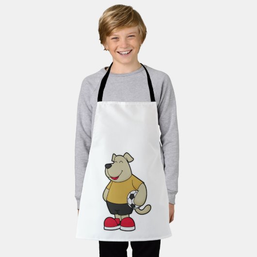 サッカーボールを持つサッカー選手の犬 エプロン (着用した状態)