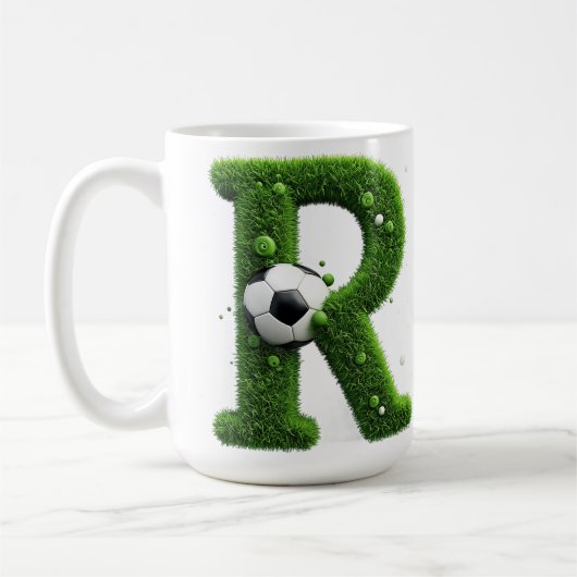 サッカーボール付き芝生のオブジェ文字 コーヒーマグカップ (左)