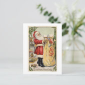 サンタがあふれ出るおもちゃのバッグを保持 シーズンポストカード (スタンド正面)