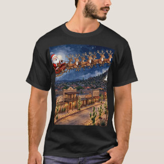 サンタがオールドプエブロの上空をクリスマスに飛ぶTシャツ Tシャツ