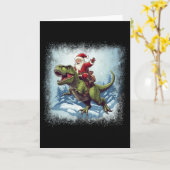 サンタが恐竜ティラノサウルスに乗るおもしろクリスマス カード (黄色い花)