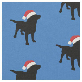 サンタのクリスマスの帽子を身に着けている黒い実験室犬 ファブリック