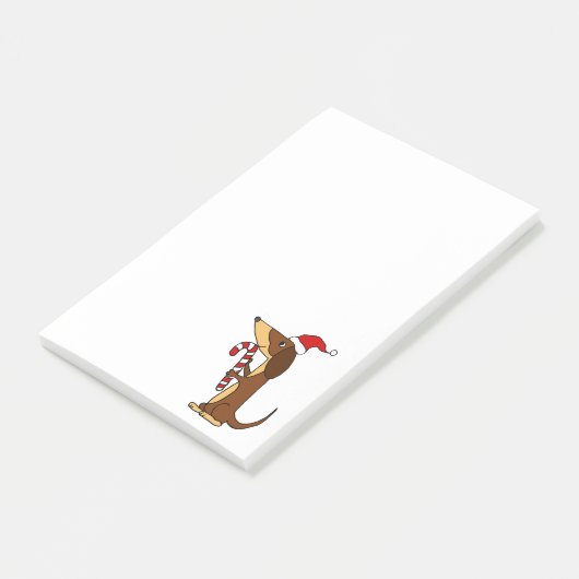 サンタの帽子のクリスマスの漫画のかわいいダックスフント犬 ポストイット (アングル)