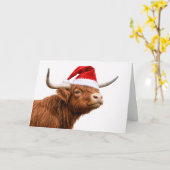サンタの帽子をかぶったキュートなハイランドコウボウイ クリスマス カード (黄色い花)