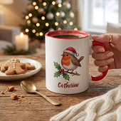 サンタの帽子をかぶったクリスマスのコマドリの名入れグッズ マグカップ