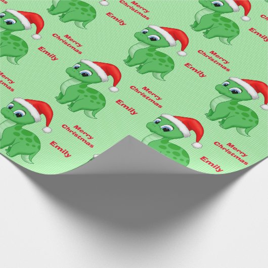 サンタの帽子を持つかわいい緑のベビーDinosour ラッピングペーパー (角)