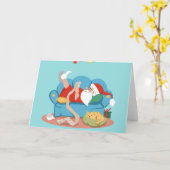 サンタクロースがパジャマでソファに座っている カード (黄色い花)