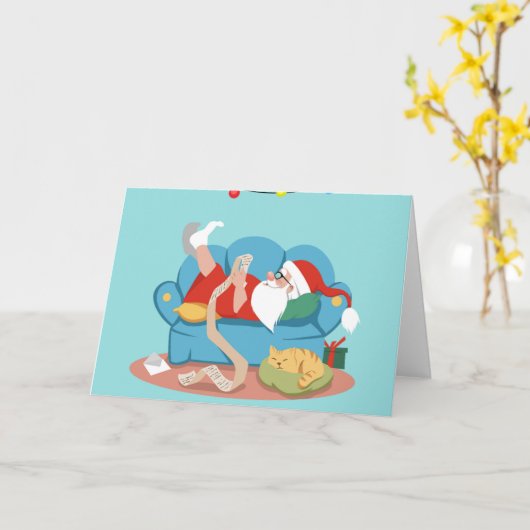 サンタクロースがパジャマでソファに座っている カード (黄色い花)