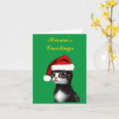 サンタクロースの帽子をかぶったかわいい猫のブランク カード (黄色い花)