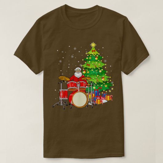 サンタクロース遊ドラム近くのクリスマスツリーおもしろい Tシャツ (デザイン正面)