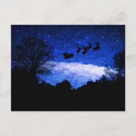 サンタクロース飛んでいるがクリスマスの夕暮れ中 ポストカード