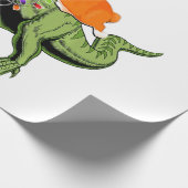 サンタコーギに乗る少年のTレックスのクリスマ ラッピングペーパー (角)