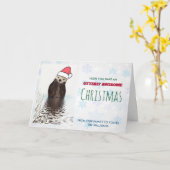 サンタハットのクリスマスを着たかわいいカワウソ カード (黄色い花)