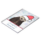 サンタハットのクリスマスを着たかわいいカワウソ ノートブック (左側)