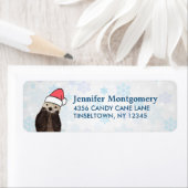 サンタハットのクリスマスを着たかわいいカワウソ ラベル (インサイチュ)