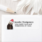 サンタハットのクリスマスを着たかわいいカワウソ ラベル (インサイチュ)